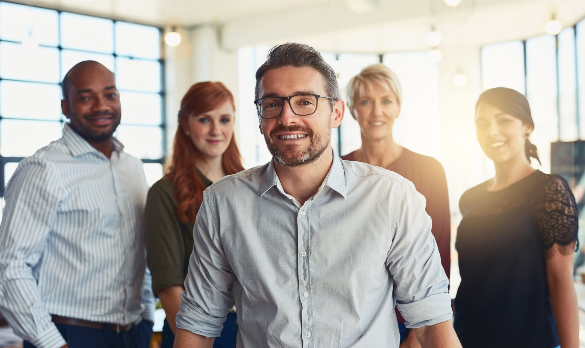 Portrait of a group of designers standing in an office
